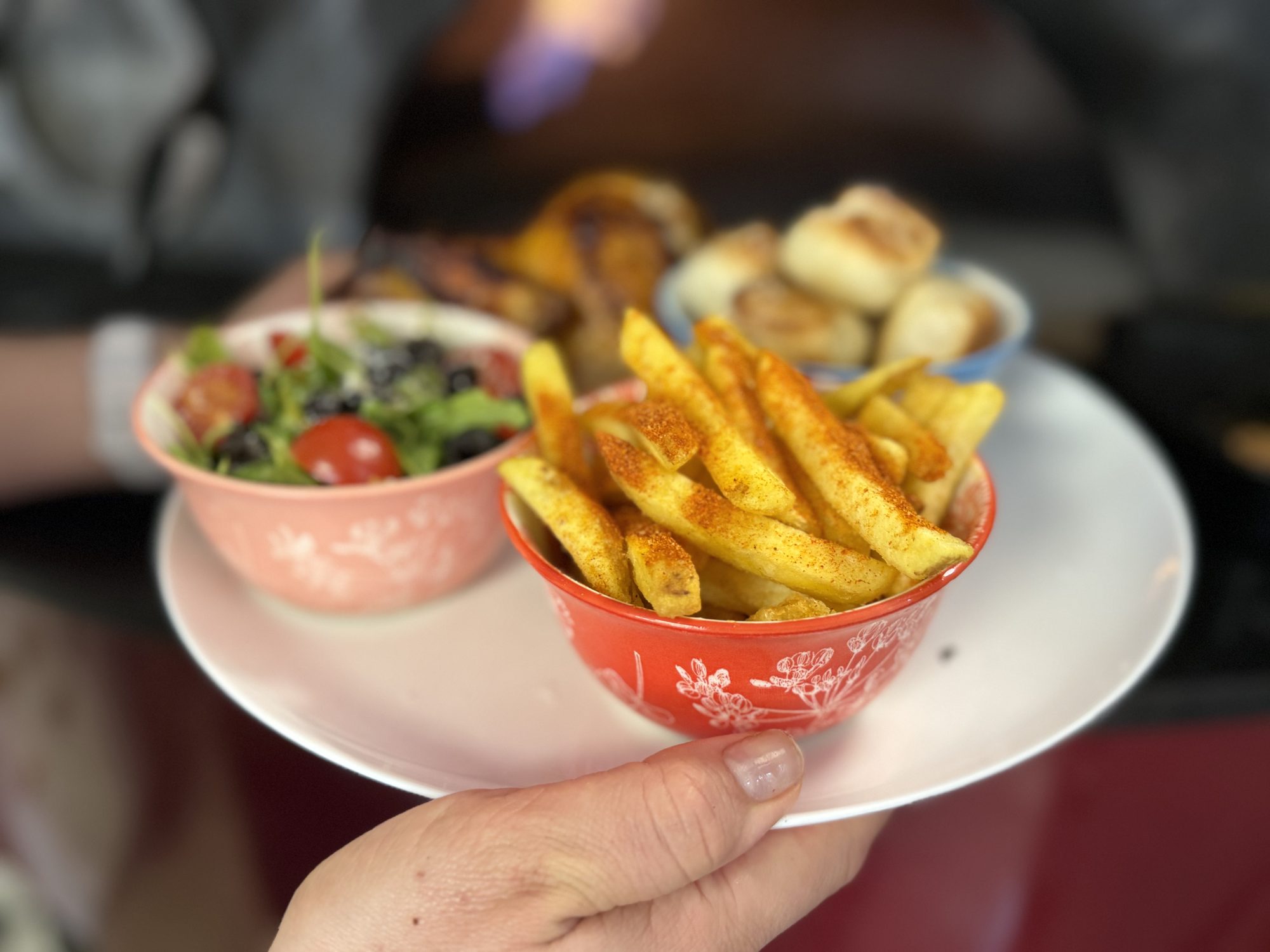 Italian-style plate with chicken, fries, dough balls and salad